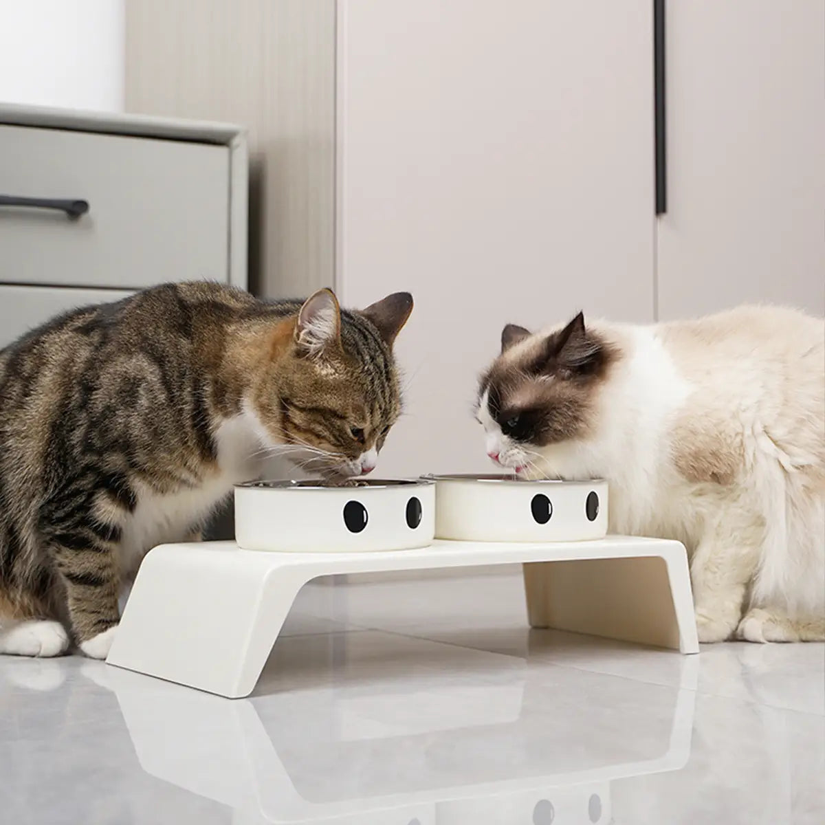 elevated dog feeder raised stand with white stainless steel food bowls featuring black circular eyes designed as smiling faces