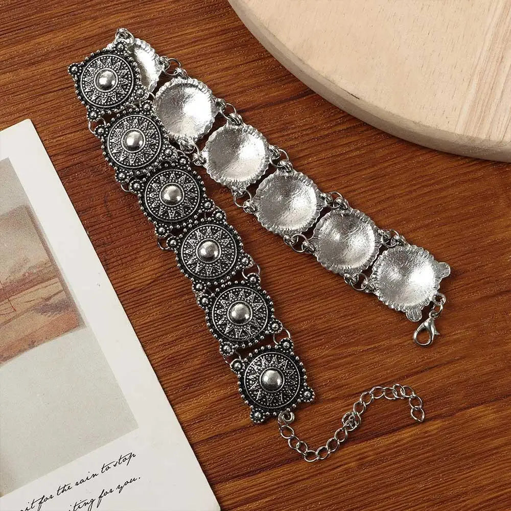 Boho silver vintage jewelry set featuring a silver-toned bracelet with ornate circular medallions embossed with intricate patterns and a chain clasp.