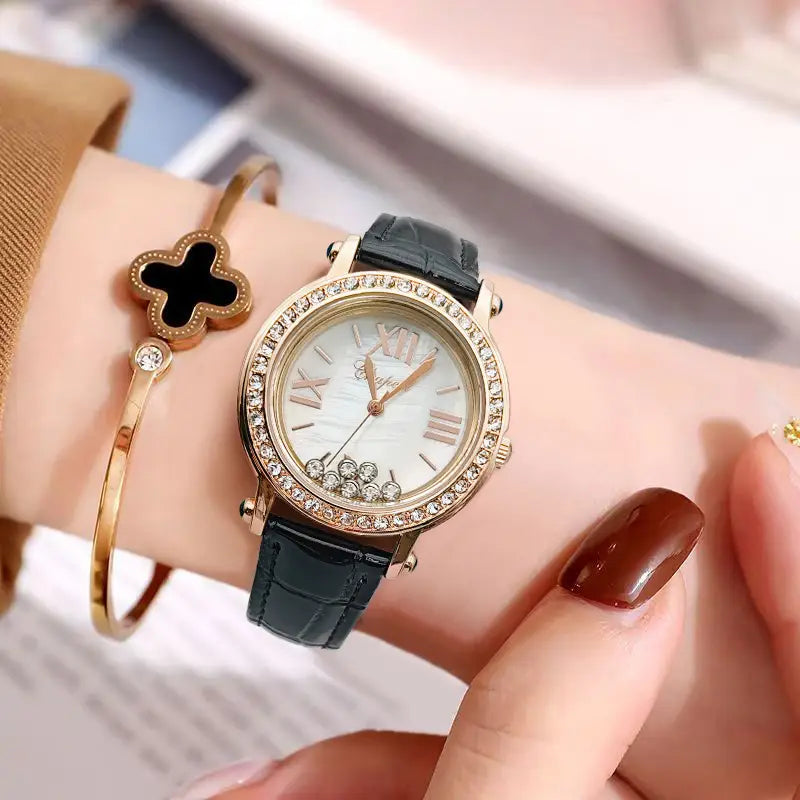 A delicate green leather crystal women watch featuring a rose gold case with a white dial, roman numerals, sparkling diamond bezel, and a sleek black crocodile leather strap.