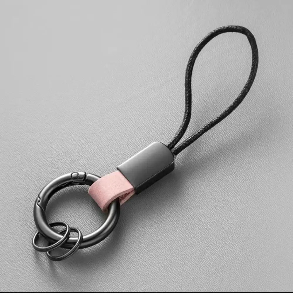 Leather carabiner keychain multifunctional key holder with a black metal matte finish ring, pink leather strap, and black cord loop.