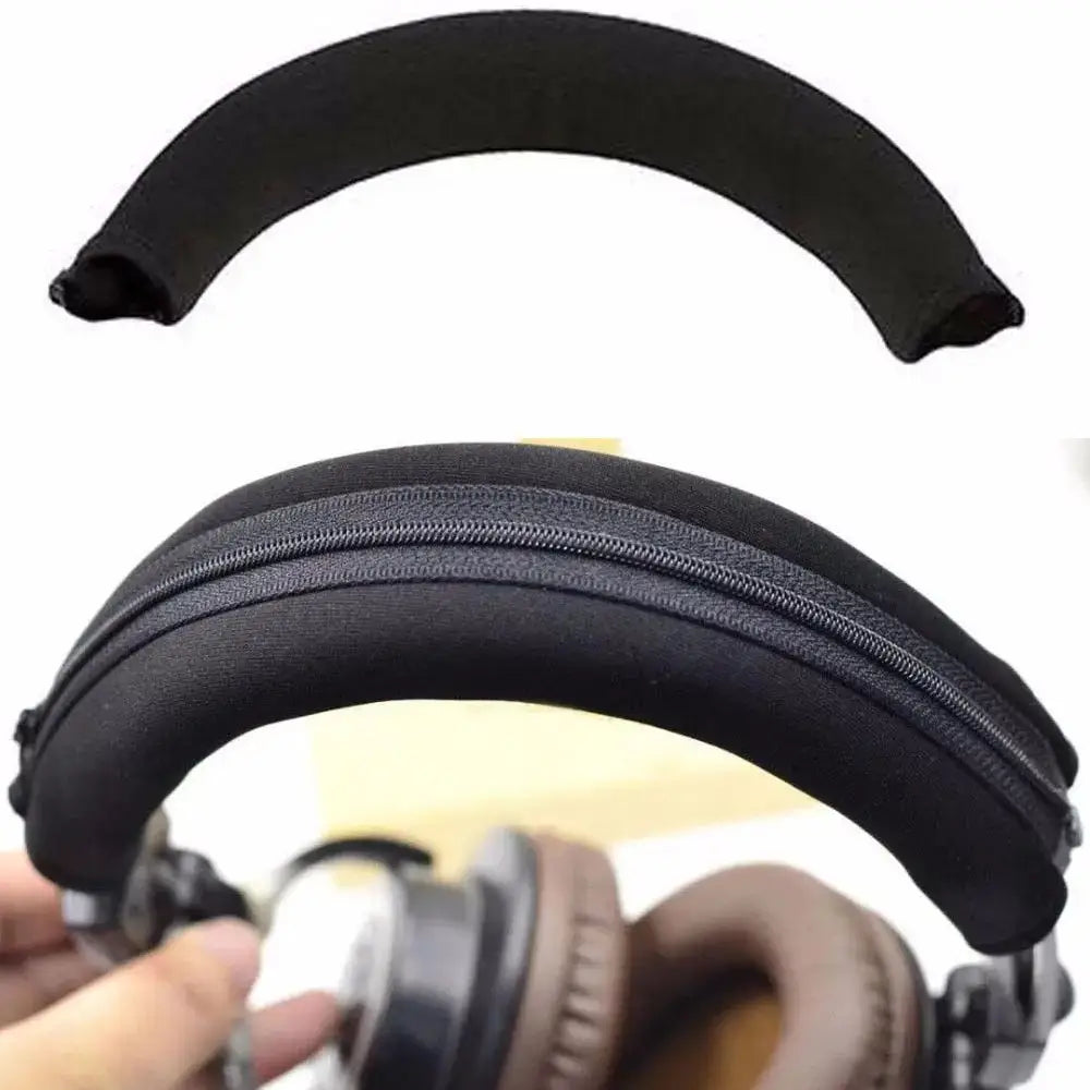 Black padded neoprene headphone headband cover with zipper closure designed for over-ear headphones.