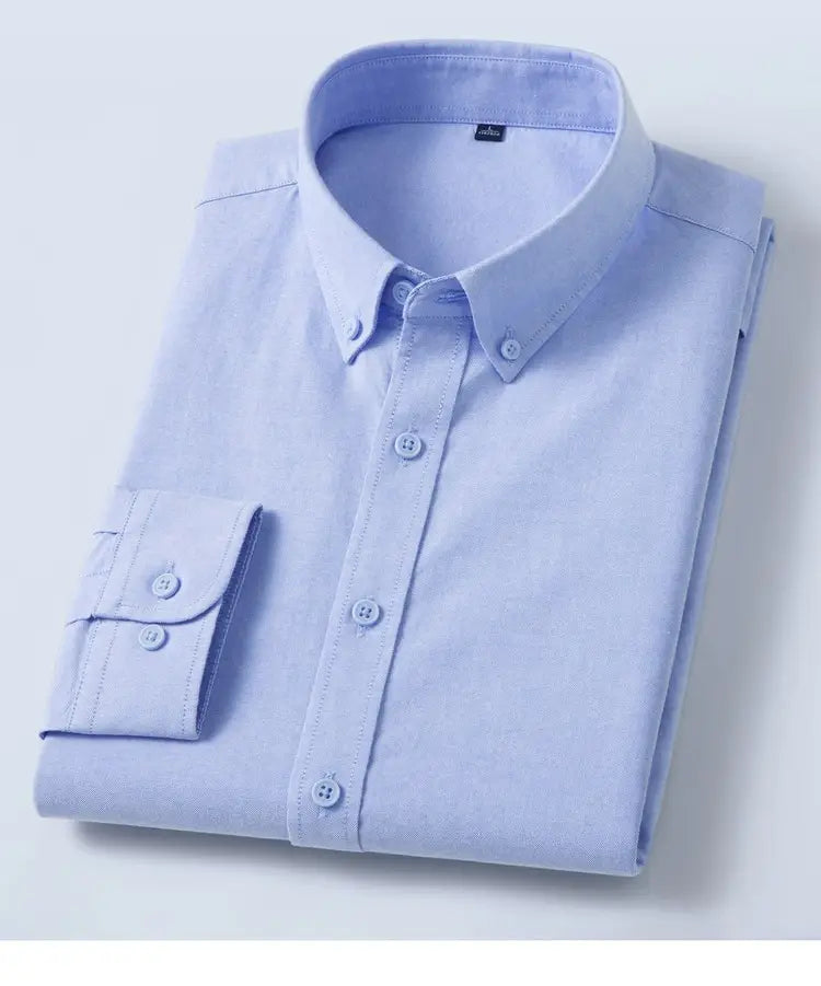 Camisa Oxford de algodón color azul claro, corte slim fit, para hombre, doblada con esmero, con cuello clásico y botones a juego.