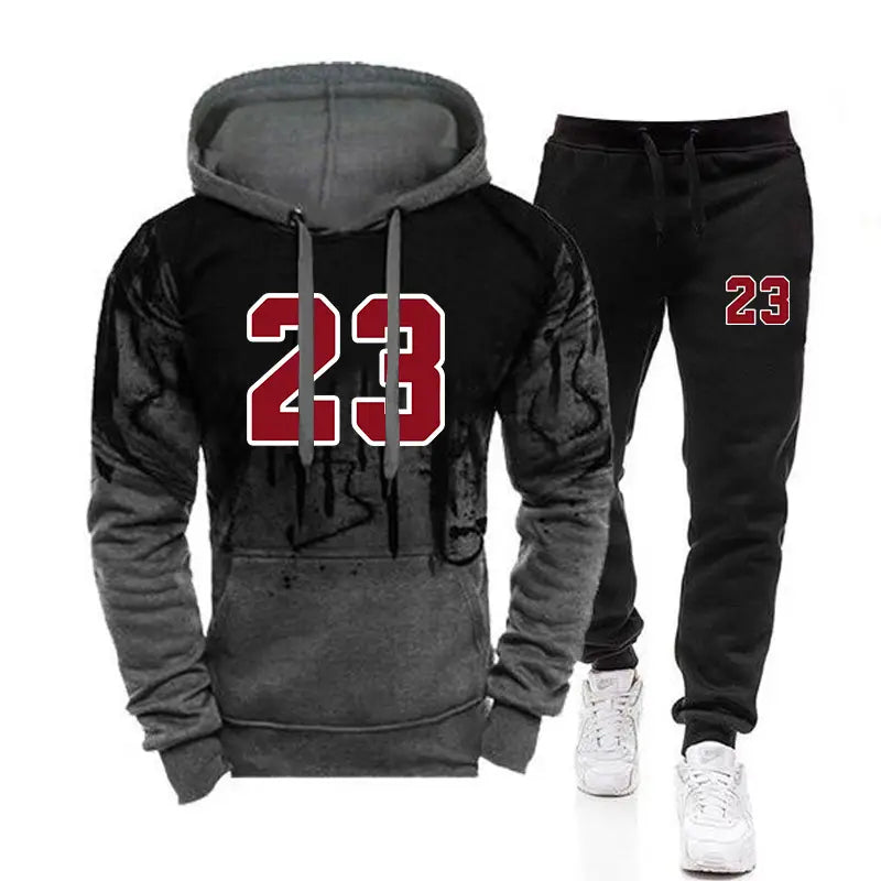 Ensemble sweat à capuche et jogging pour homme portant le numéro 23 en noir et gris, avec un graphique rouge sur l’avant, associé à des joggers noirs assortis arborant une conception de numéro similaire.