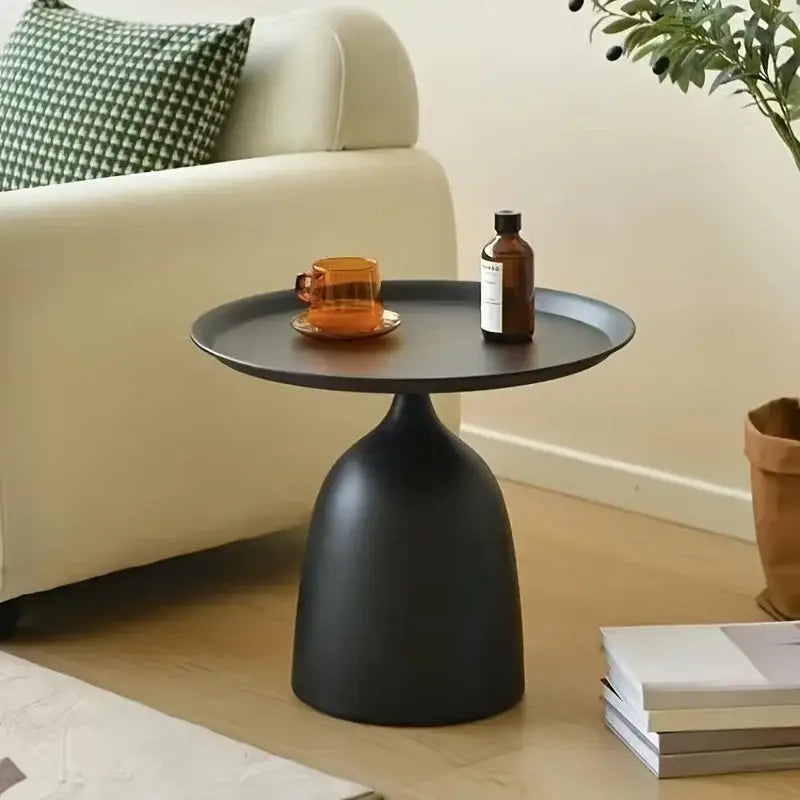 Black matte-finished modern living room side table with a sleek bell-shaped base and circular top ideal as a coffee table.