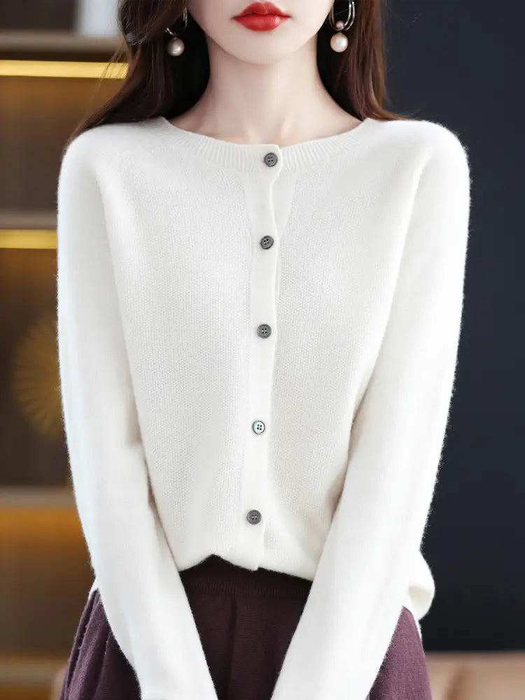 a soft white merino wool cardigan for women with a round neckline and five dark gray buttons down the front