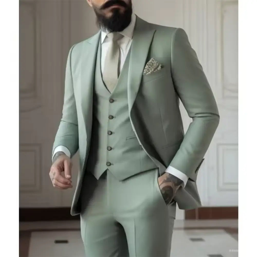 Ein eleganter hellsalbeigrüner Dreiteiler für Herren mit maßgeschneiderter Passform und dezent strukturierter Webart.