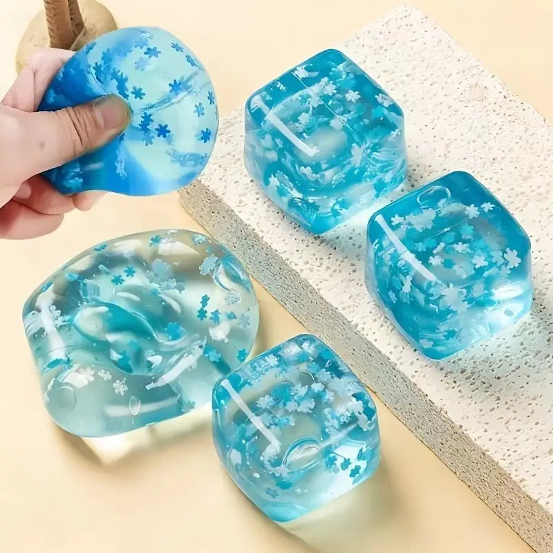 blue translucent slow rising squishy stress ball with embedded white flower patterns shaped like ice cubes for sensory fidget use