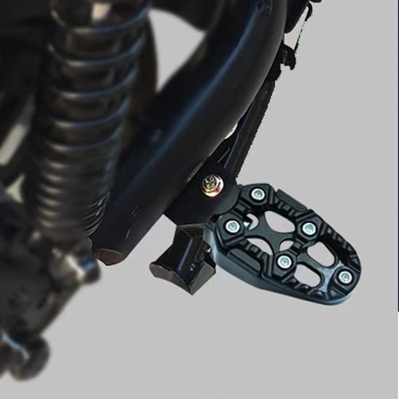 black textured cnc aluminum motorcycle footpeg with a rugged multi-lobed design and silver bolts shown from the back side for rear anti slip pedals.