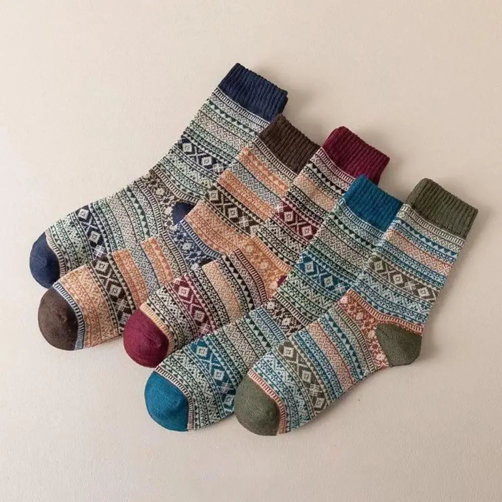 a set of five men retro cotton mid-high tube crew socks in teal with cozy earthy tones, muted blues, and geometric patterns reflecting the fashion trend of thermal knitwear.