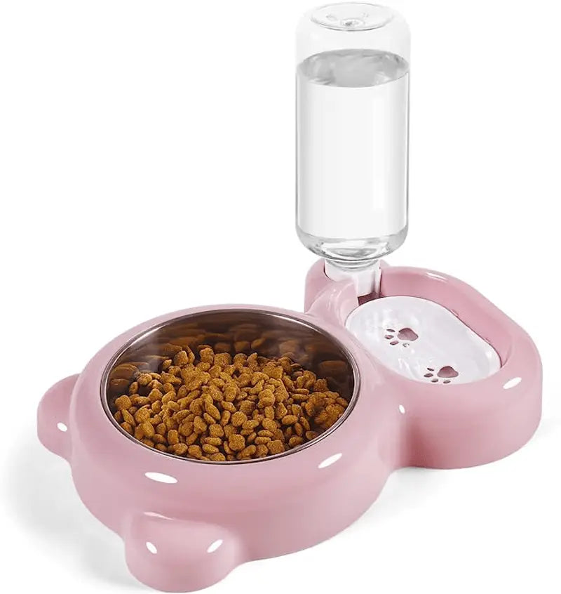 Juego de comedero y bebedero para mascotas con forma de oso en color rosa, que incluye una botella de agua transparente y un cuenco de comida de acero inoxidable lleno de pienso.