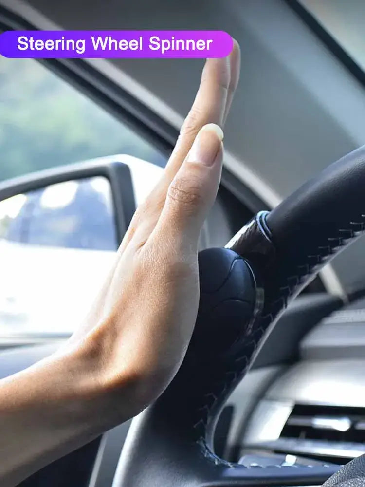 Black leather steering wheel spinner knob with textured grip and stitched edges for 360 degree turn assist.
