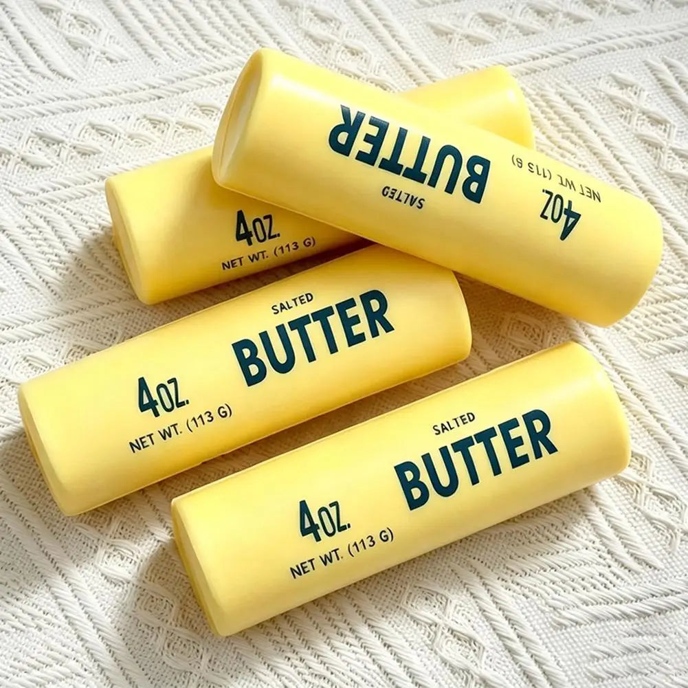 Yellow salted butter sticks labeled 4oz featured as a slow rising squeeze toy resembling a butter stick for sensory play.