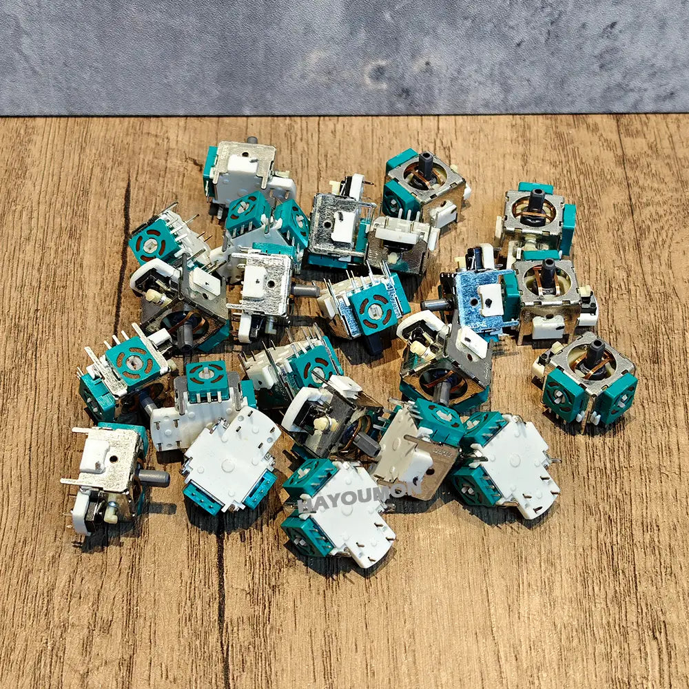 Teal and white plastic potentiometers for ps2 analog stick joystick replacement showing detailed components for stick joystick repair.