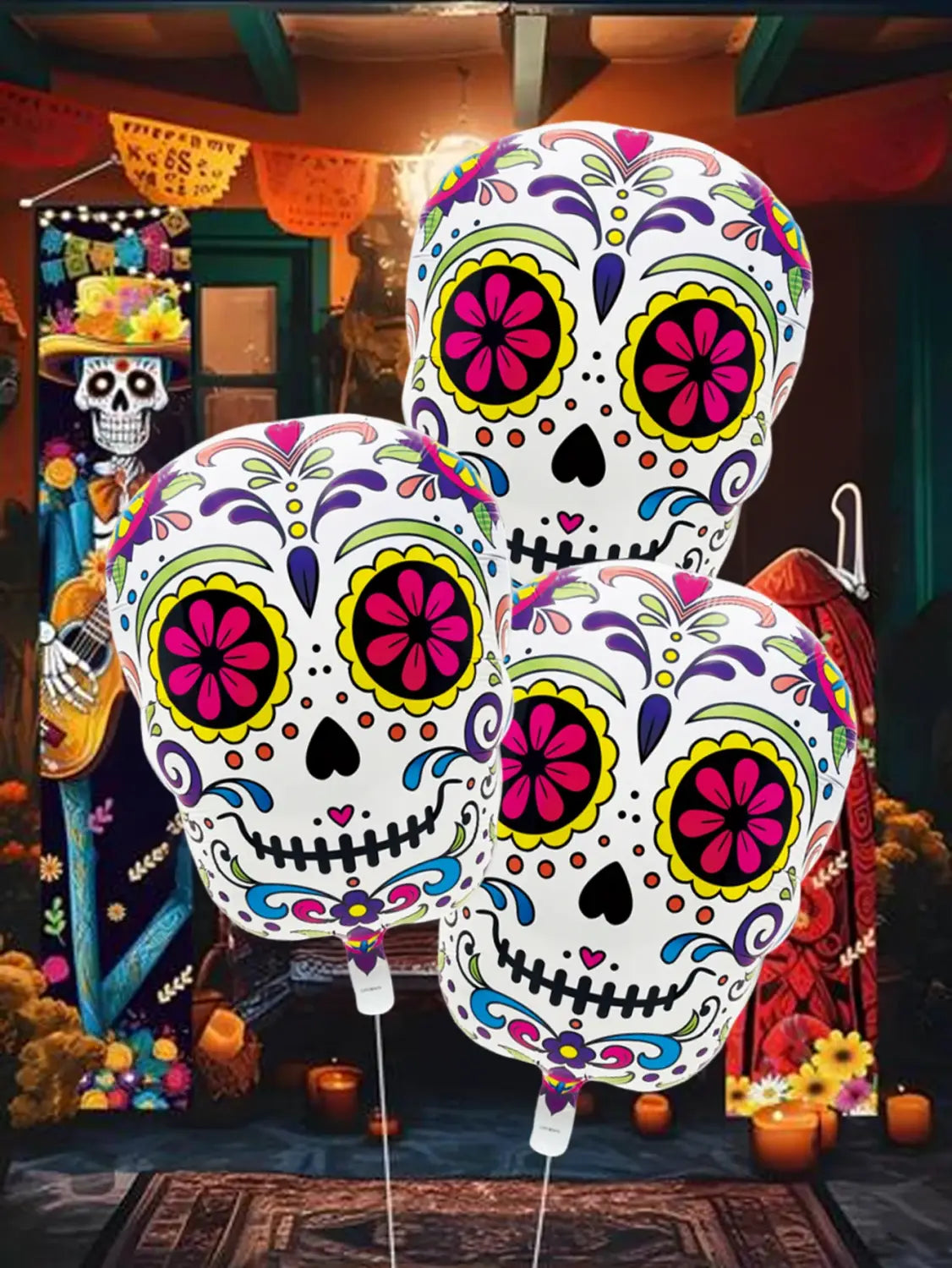 three vibrant sugar skull-themed foil balloons in pink yellow and purple featuring intricate colorful flower skull patterns on a white background colorfull flower skull foil balloons 3 pack