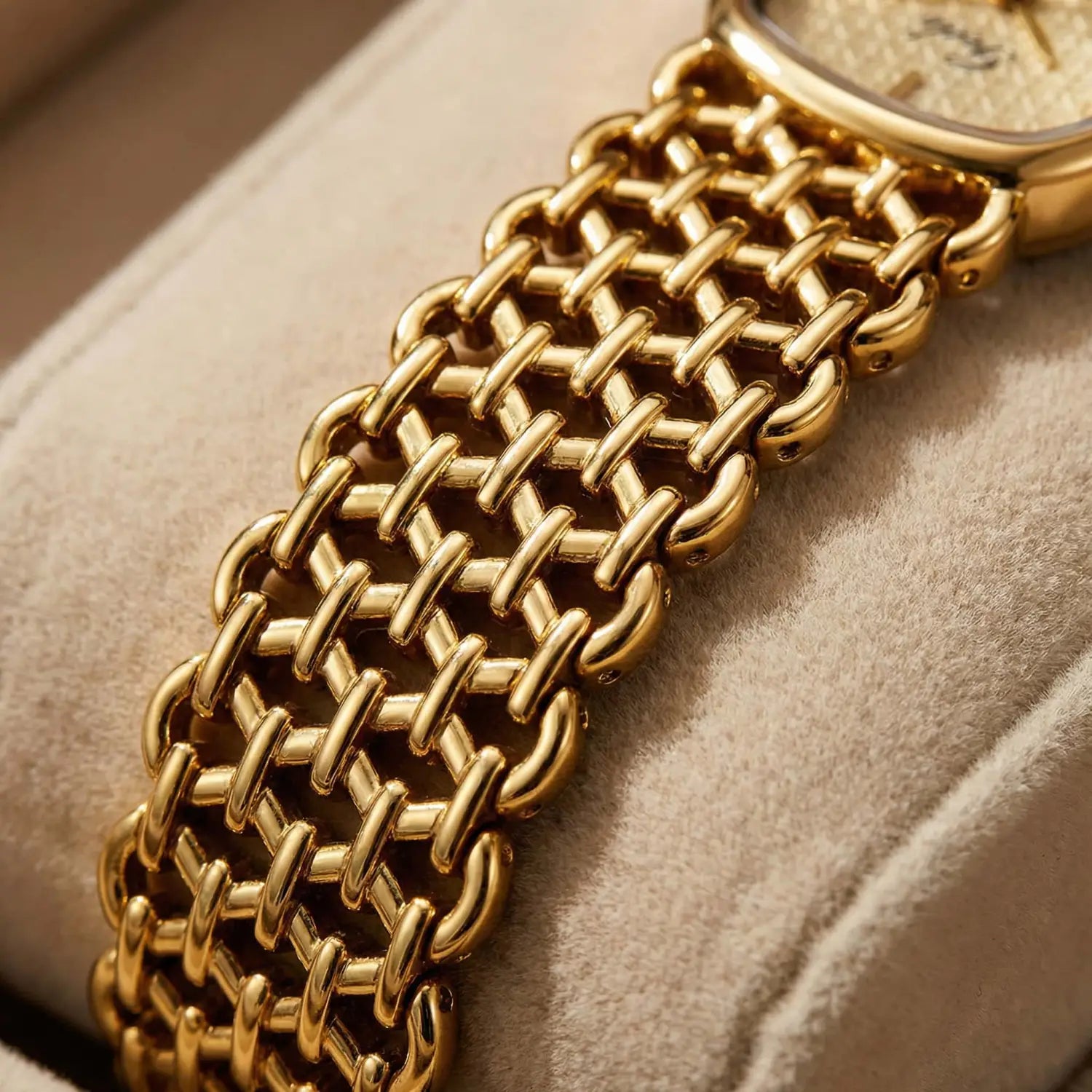 Gold-toned woven mesh bracelet with a textured interlocking chain design for an elegant women watch quartz timepiece.