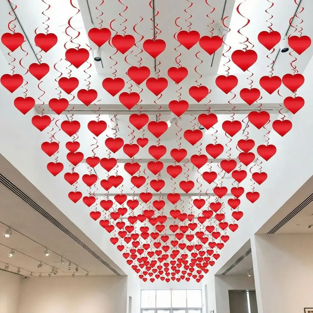 Red heart-shaped ceiling decorations made of swirl streamers perfect for valentine party hangings.