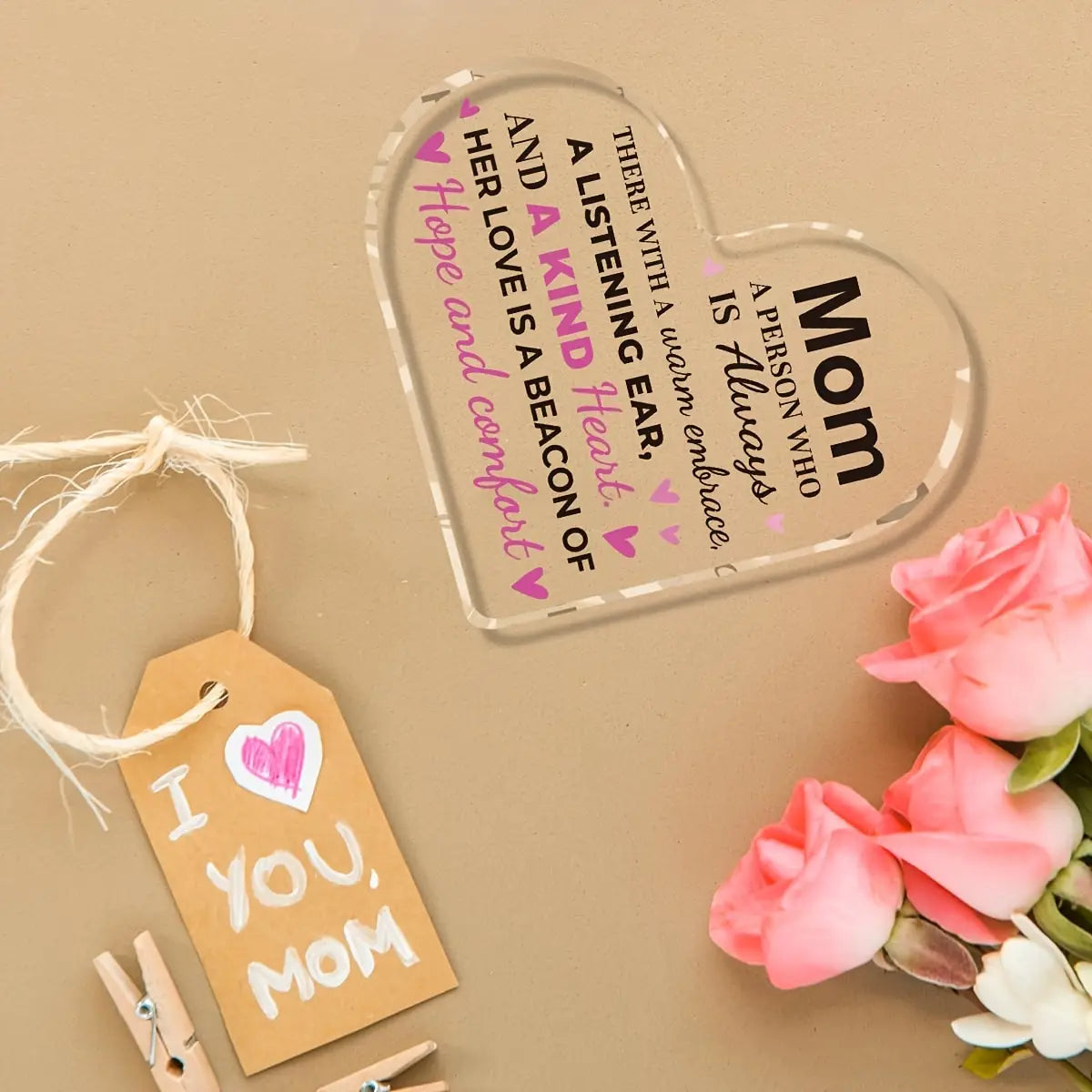 Clear heart-shaped acrylic plaque with engraved black and pink mom text and a heartfelt message accented by small pink hearts in a mom acrylic heart keepsake gift.