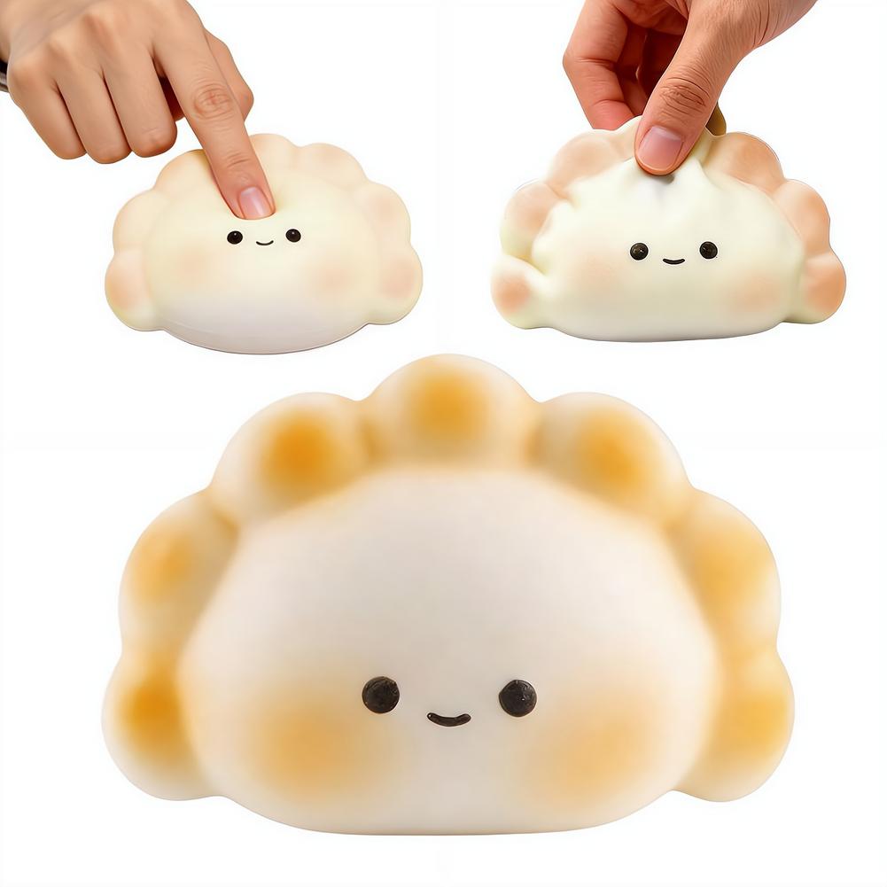 Lindo juguete exprimible de dimsum en color blanco y beige para aliviar el estrés, tipo fidget, con ojos de puntos negros y boca sonriente, diseñado para aliviar el estrés.