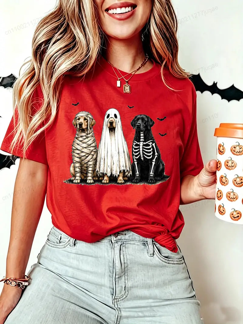 Red short sleeve women’s t-shirt featuring a Halloween dog graphic with three dogs dressed as mummy ghost and skeleton.