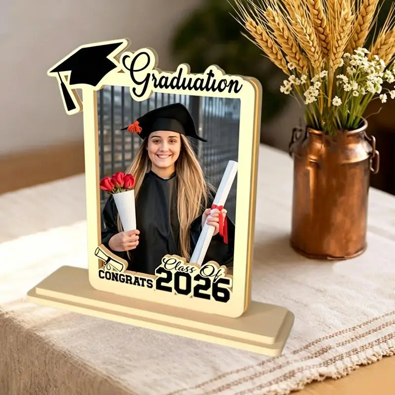 Beige wooden graduation photo frame with black decorative elements and class of 2026 inscription for displaying graduation photos.
