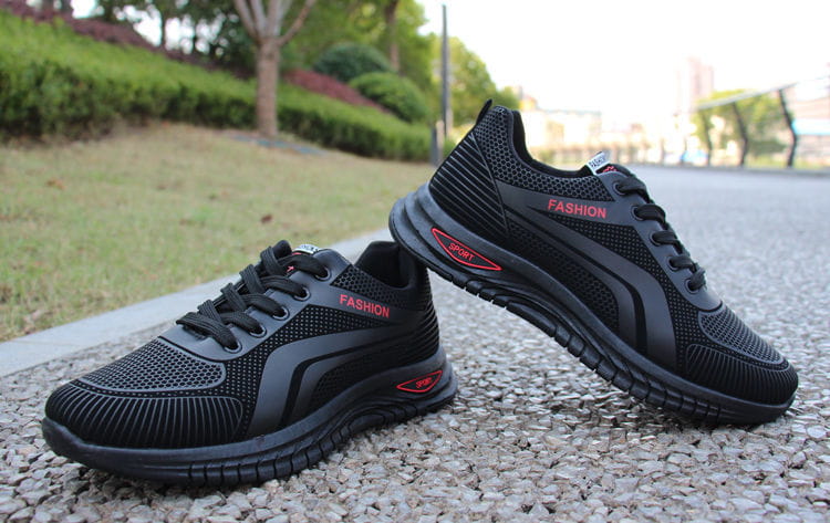 Men breathable athletic sneakers running shoes in black mesh with red fashion branding and a textured rubber sole.