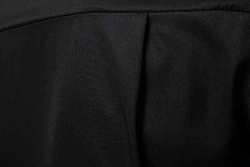 black fabric with a smooth slightly textured surface and subtle pleats along the seam on the men asymmetrical slant collar long sleeve casual shirt