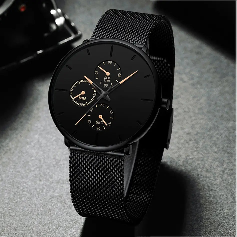 Montre à quartz à maille noire ultrafine pour hommes, avec un design minimaliste élégant, trois sous-cadrans et des aiguilles en or rose.