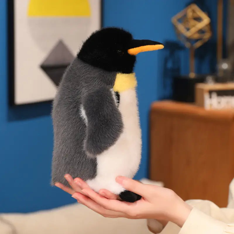 A plush penguin stuffed animal soft toy pair featuring a black head gray back white belly and yellow beak made of soft material.