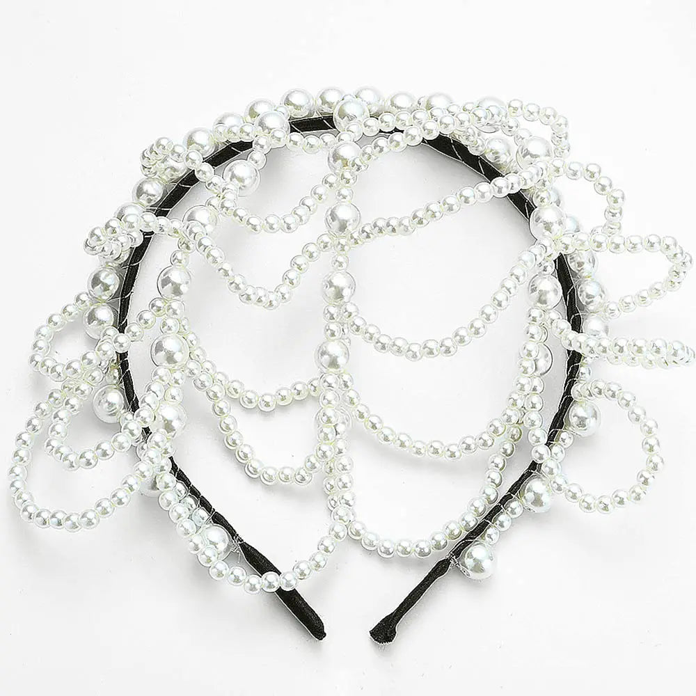 A black pearl bridal crown hair band featuring multiple strands of white pearls in varying sizes for an elegant and layered tassel headpiece design.