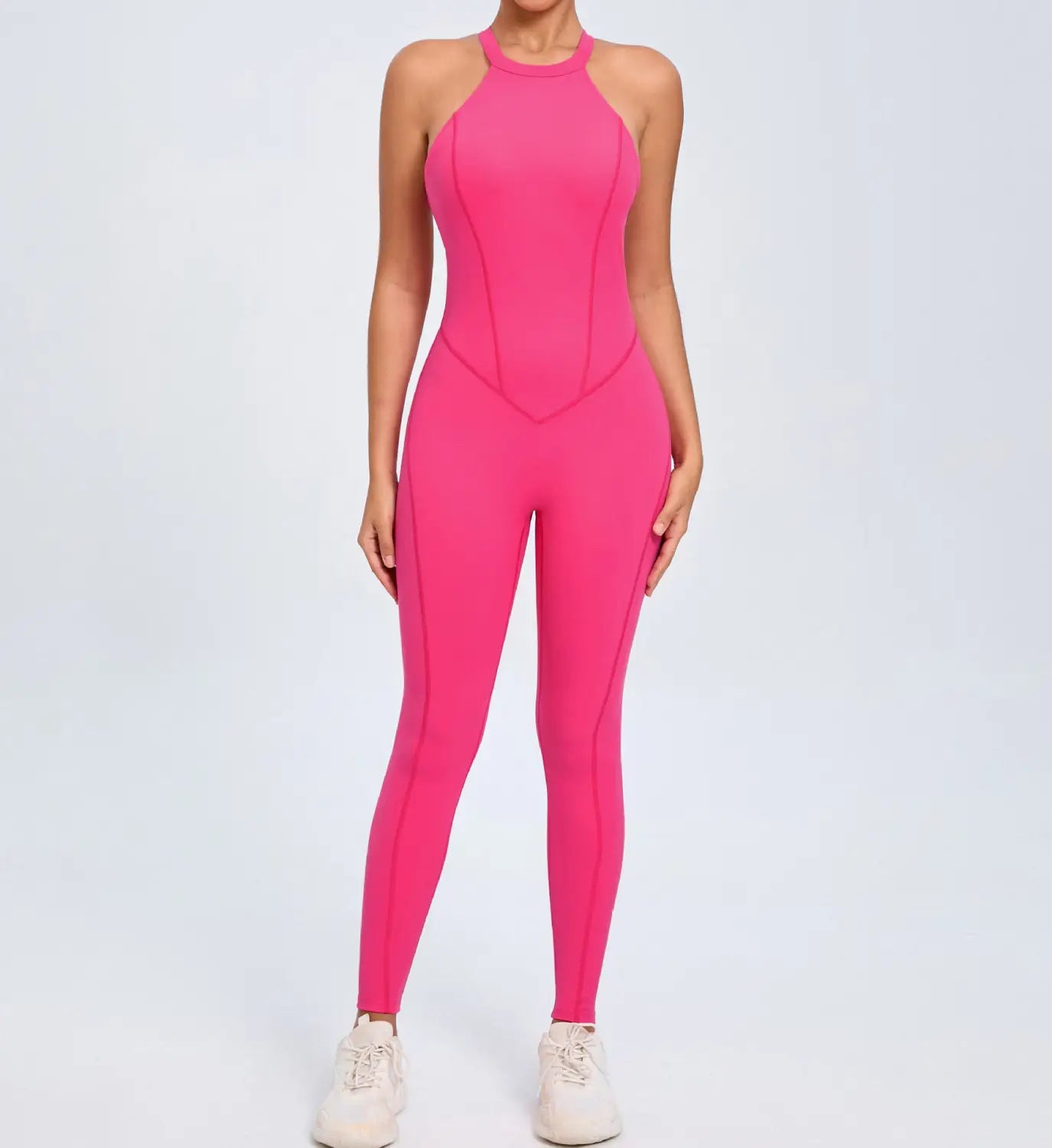 A vibrant pink high-neck seamless workout jumpsuit with subtle seam detailing shown from the back in a form-fitting athletic romper design.