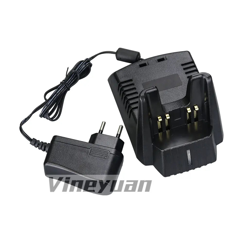 black plastic two-slot battery charger for Yaesu Vertex Standard radio with gold-colored contacts and a coiled power cord