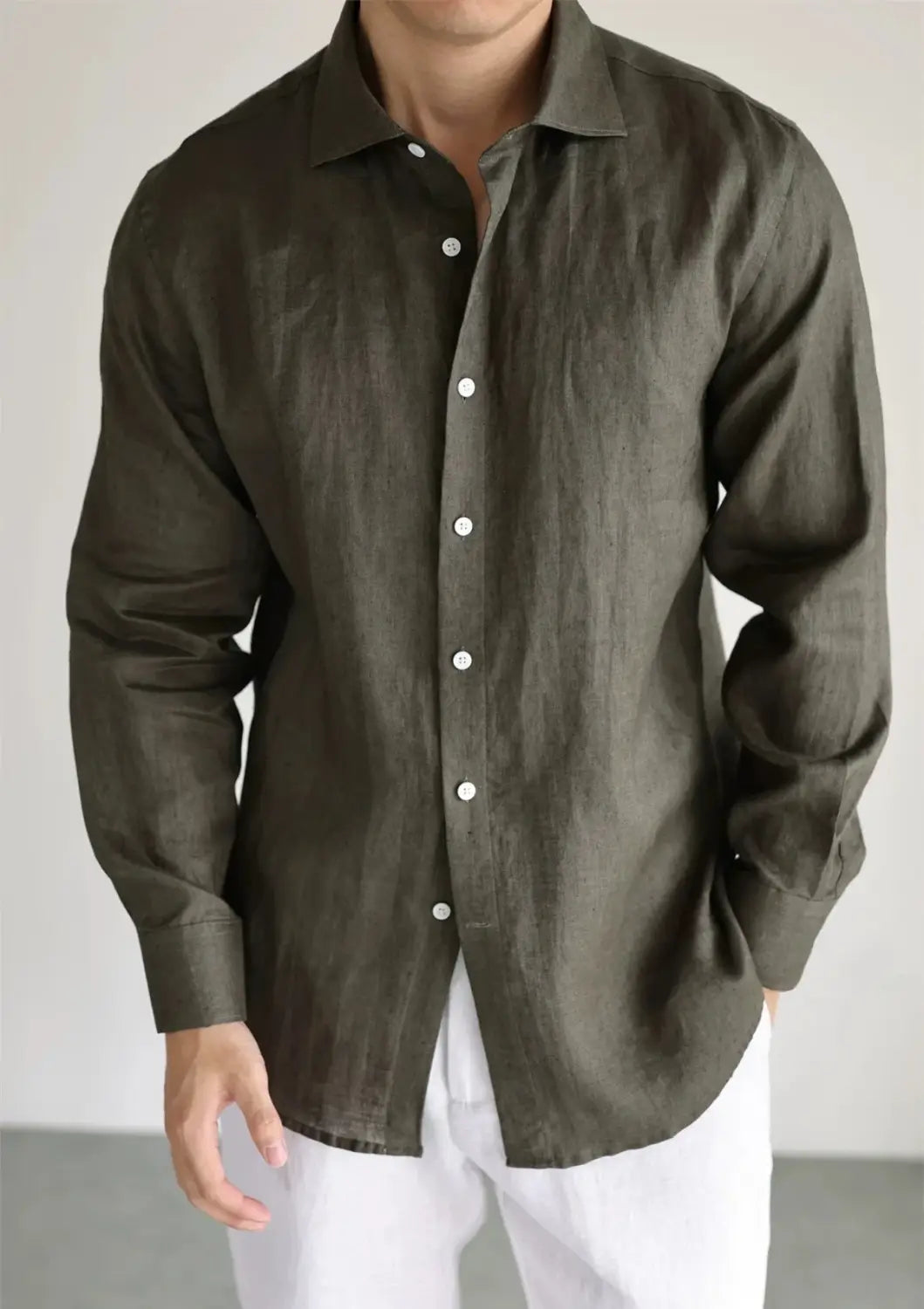a dark olive cotton linen casual button down shirt with a classic collar and white buttons