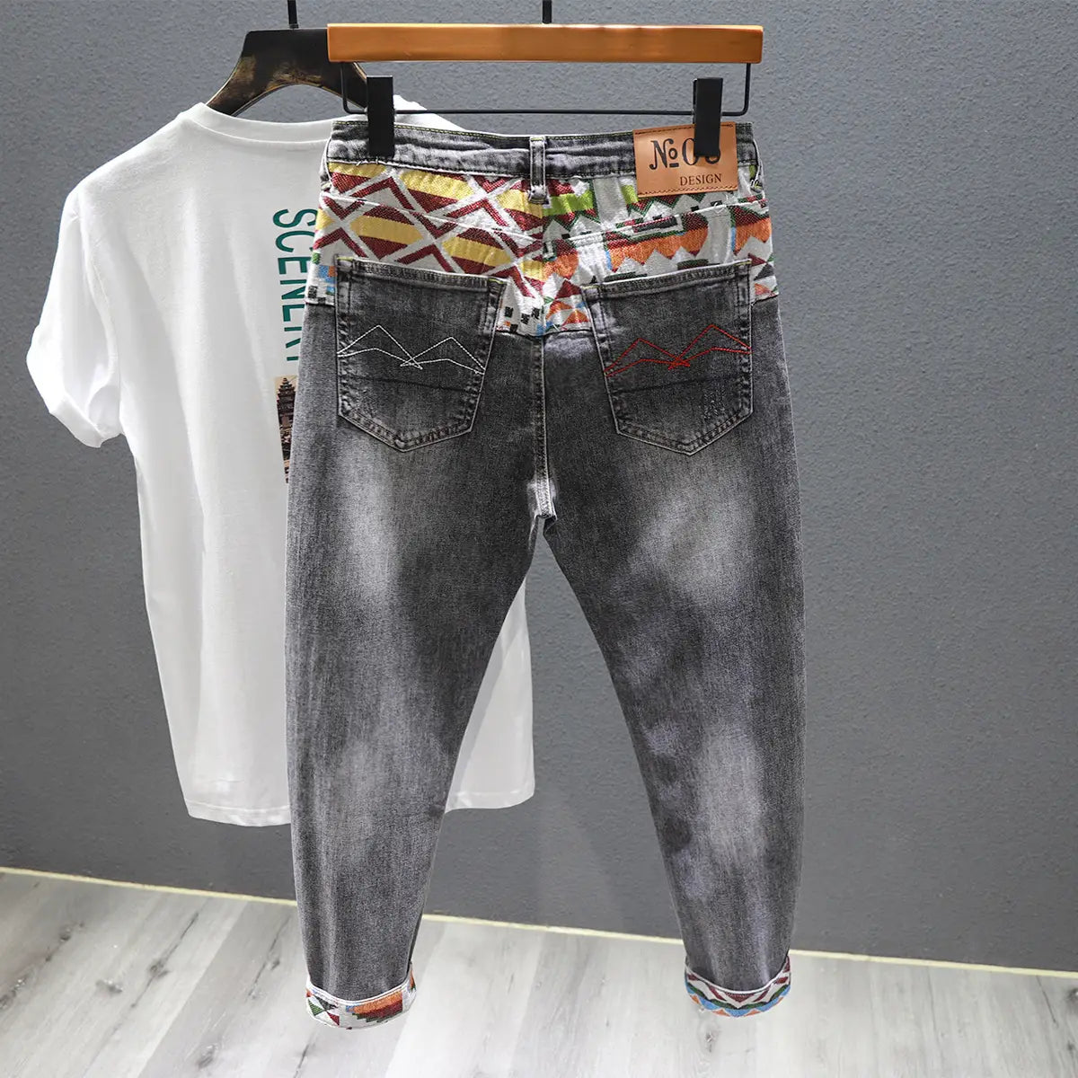 Men slim fit stretch white denim jeans featuring gray denim with colorful geometric pattern on waistband and cuffs and white stitching details.