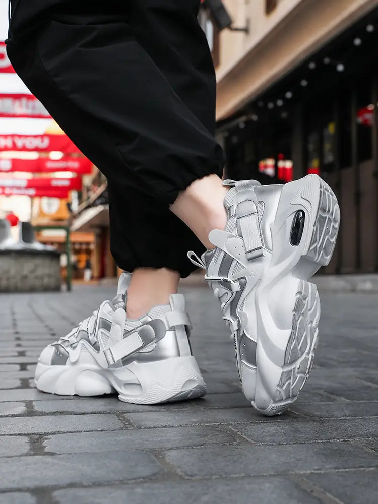 Men chunky air cushion casual sneakers in silver and white with a futuristic design featuring mesh uppers multiple strap closures and an air cushioned sole