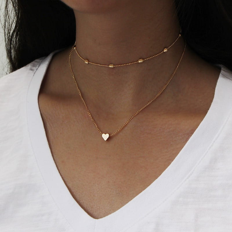 gold-toned layered alloy jewelry choker necklace for women featuring a delicate chain and small heart pendant designed to avoid contact with warm water
