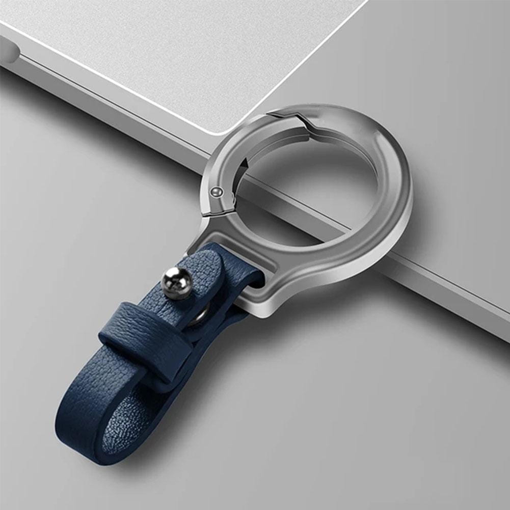 A sleek silver metal ring with a navy blue leather strap and a small metallic ball accent serves as a durable leather car keychain and metal key ring holder gift.