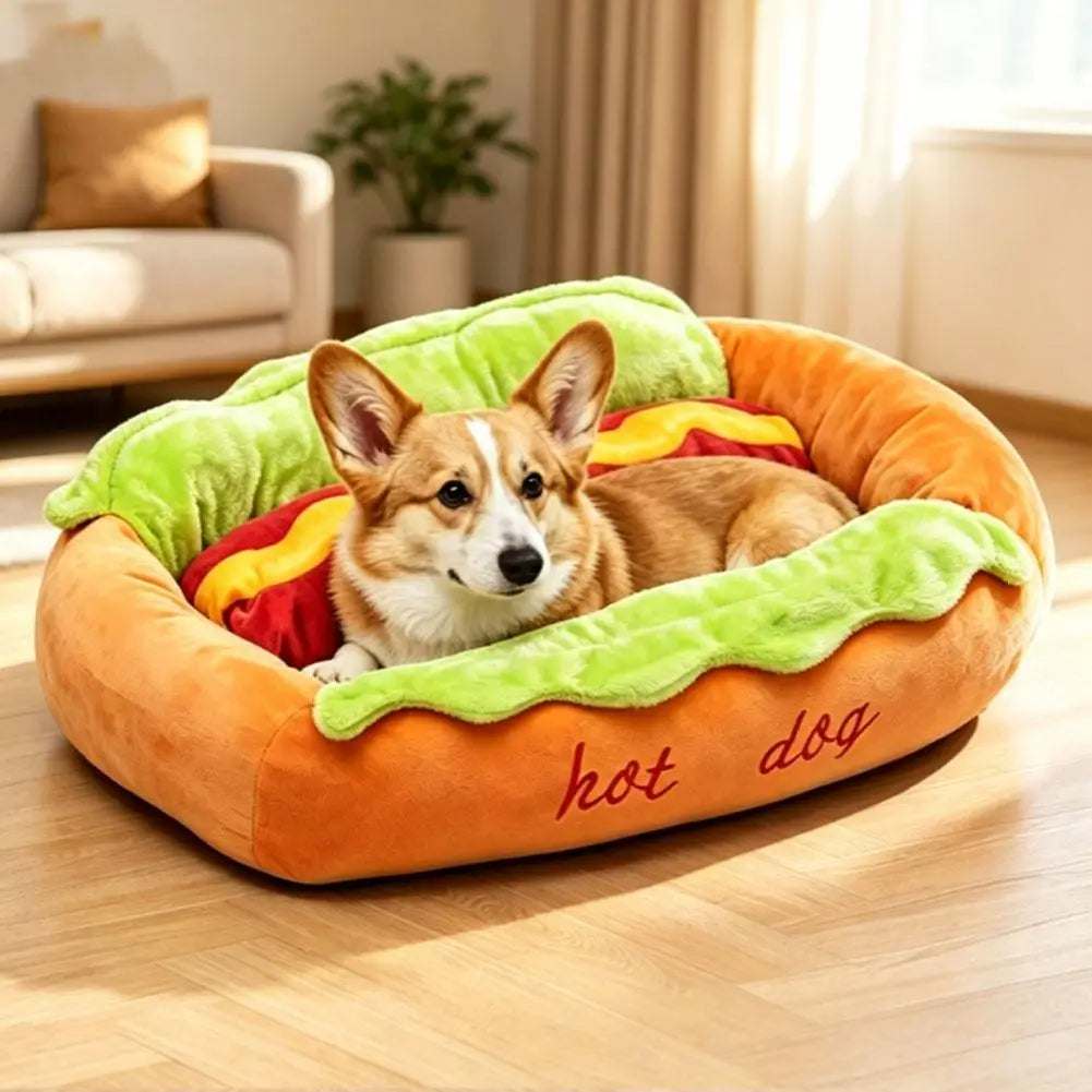 Orange plush hot dog pet bed with green lettuce and red tomato accents and embroidered hot dog text providing a comfortable resting place for cats and dogs.