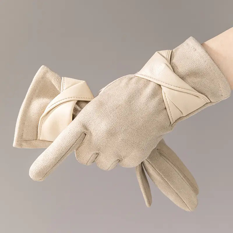 Beige suede women’s touchscreen winter gloves with a soft textured finish and a decorative knot at the wrist shown from the back side.