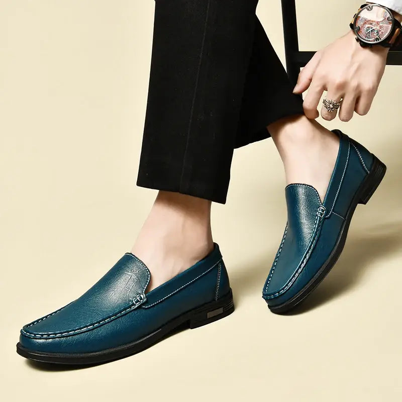 Men genuine leather slip-on dress loafers in teal with contrasting white stitching and a low-profile black sole.