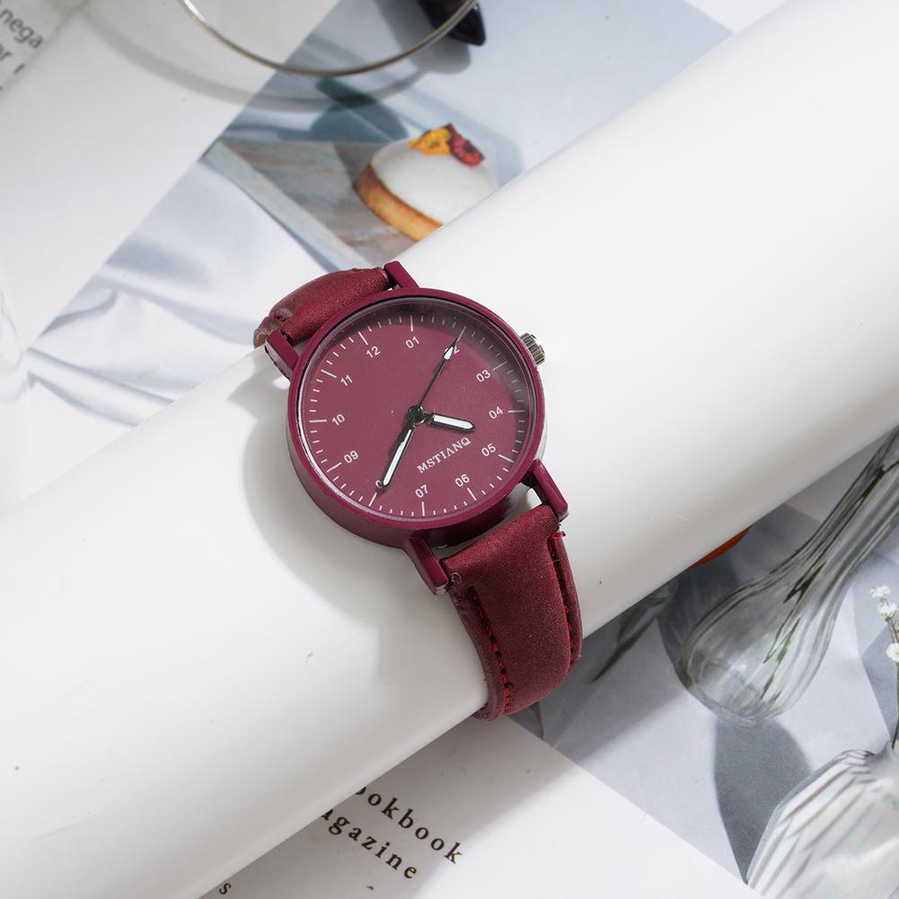 A women quartz watch with a maroon pu leather strap and matching circular face featuring minimalist black numerals designed as a waterproof wristwatch.