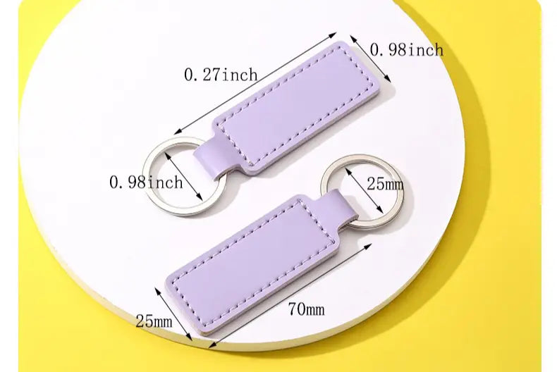 Lavender-colored rectangular leather keychain with stitched edges and silver-toned metal ring from a customized leather keychain set.