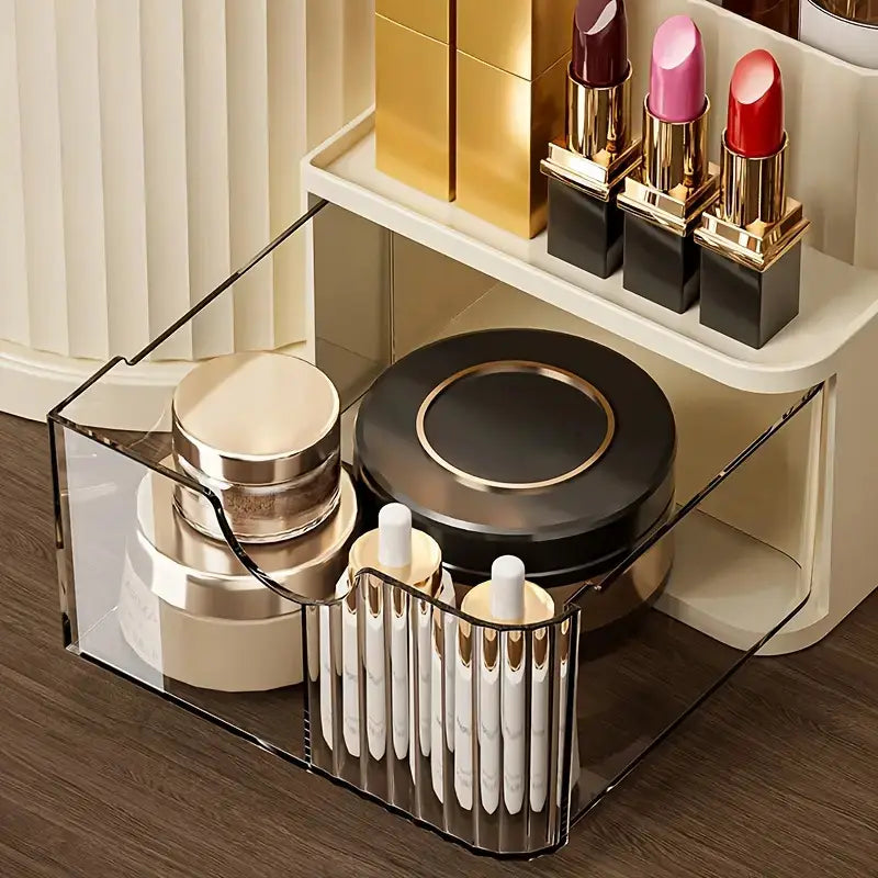 Clear acrylic makeup organizer with black metal accents and divided compartments featuring a brush holder for large capacity skincare and cosmetics storage.