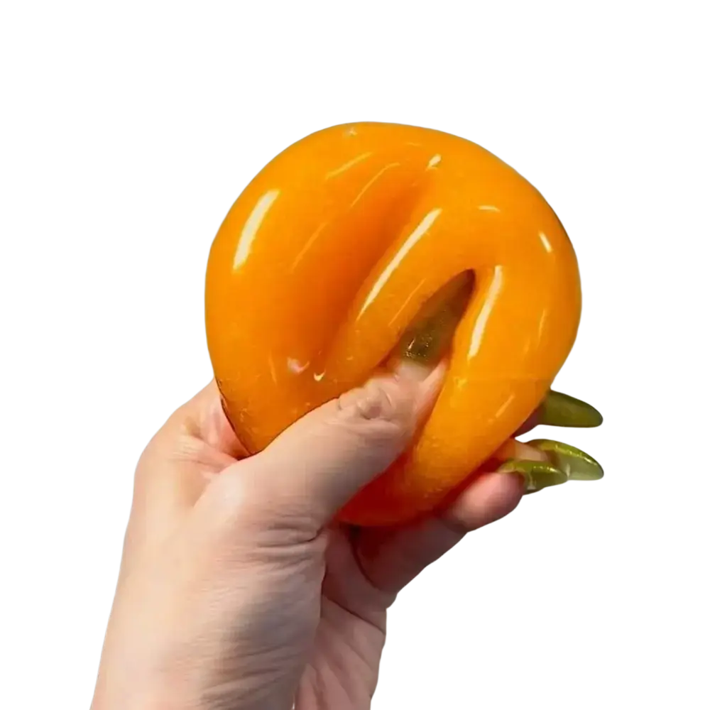 A handmade orange slushy squishy toy with a glossy silicone texture and a subtle central indentation seen from the front