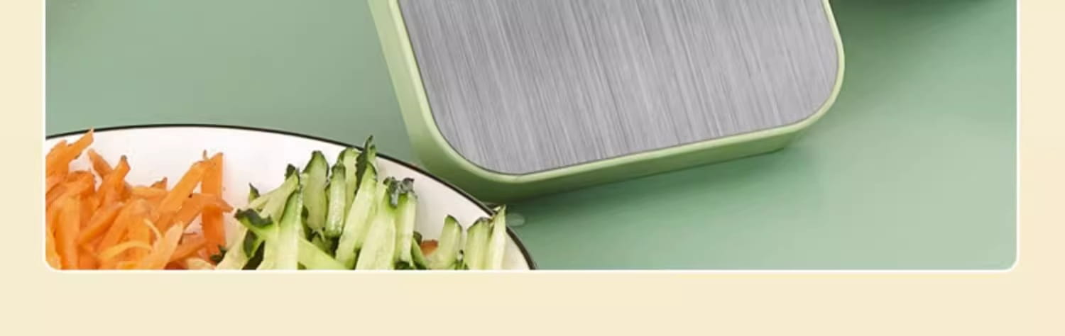 Multi-functional stainless steel vegetable slicer shredder in light green and silver with a brushed metal top.