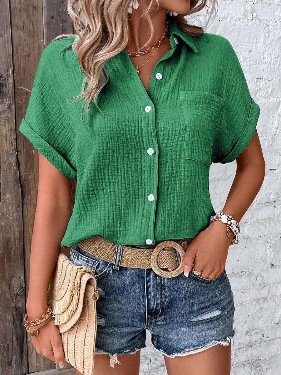 Green textured cotton women short sleeve button up shirt with rolled sleeves and a chest pocket.