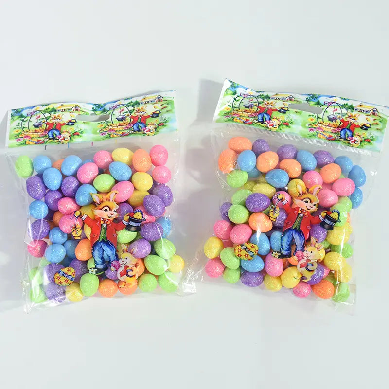 two clear plastic bags containing colorful glitter Easter foam eggs with cartoon rabbit character packaging for DIY party decor 80 pcs set