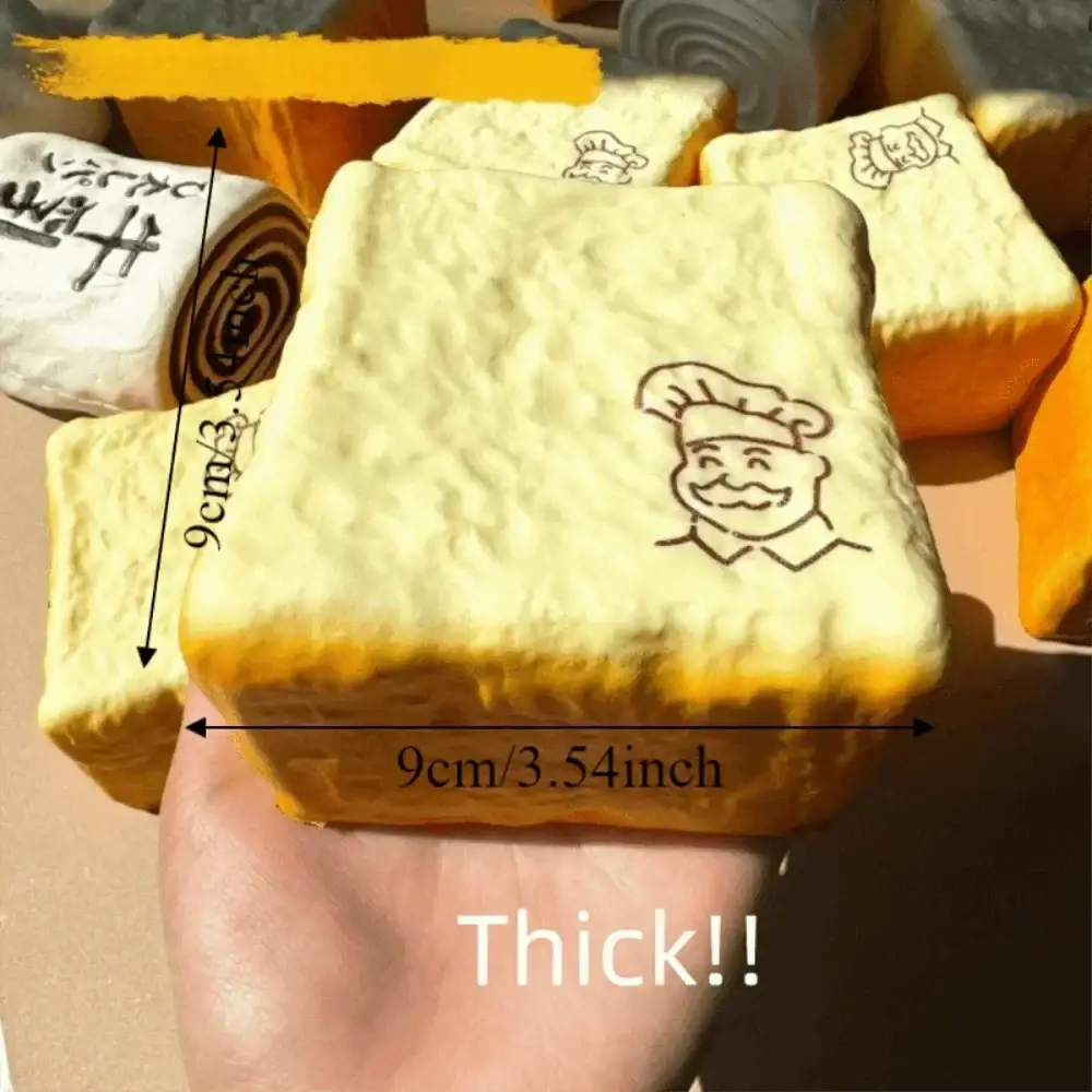 A thick pale yellow soft foam toast squishy toy with a black chef illustration suitable for universal age range fidget toy