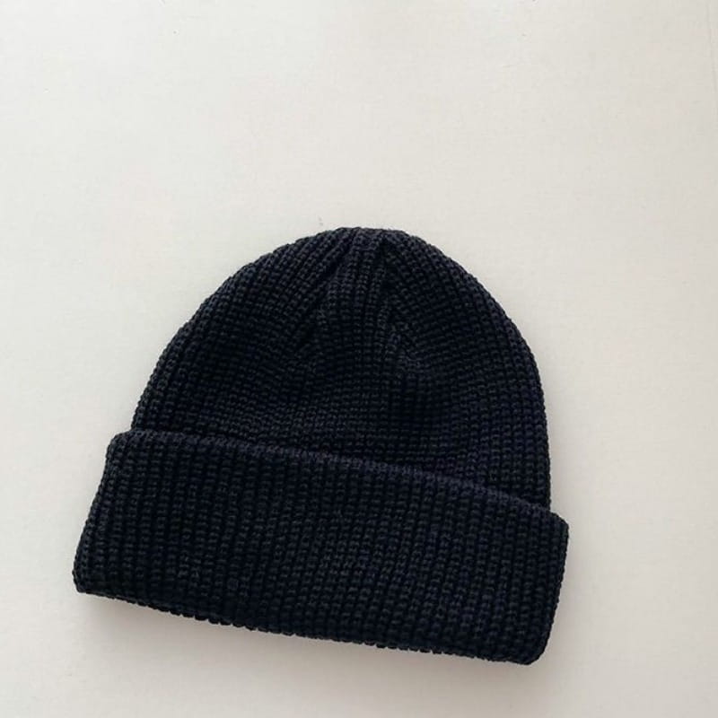 Black ribbed knit winter beanie hat with a folded cuff made of warm knitted material suitable for unisex use.