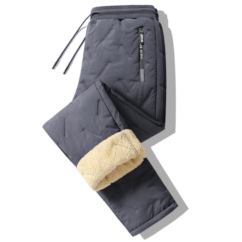 Men fleece lined thermal sweatpants in dark gray quilted fabric with plush beige fleece lining and elastic waistband designed for waterproof winter wear.