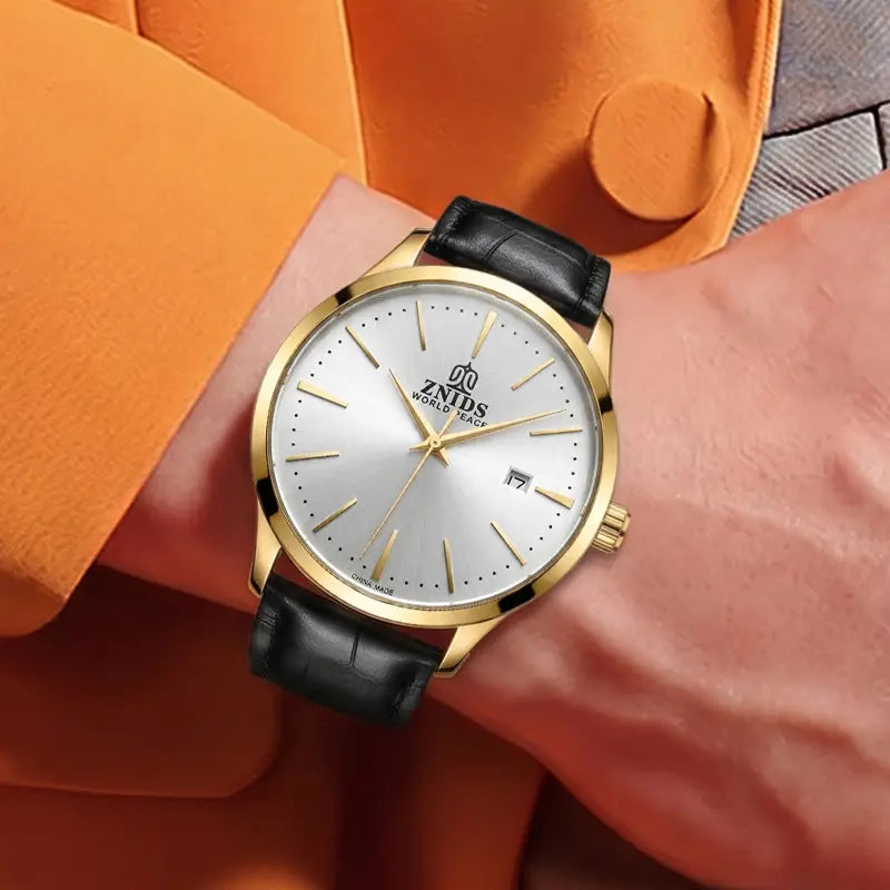 Gold-toned znids automatic skeleton mechanical wristwatch with a silver dial, black leather strap, and minimalist gold hands.